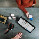 What is Biome Payments: Redefining Modern Payment Ecosystems. person holding smartphone beside tablet computer